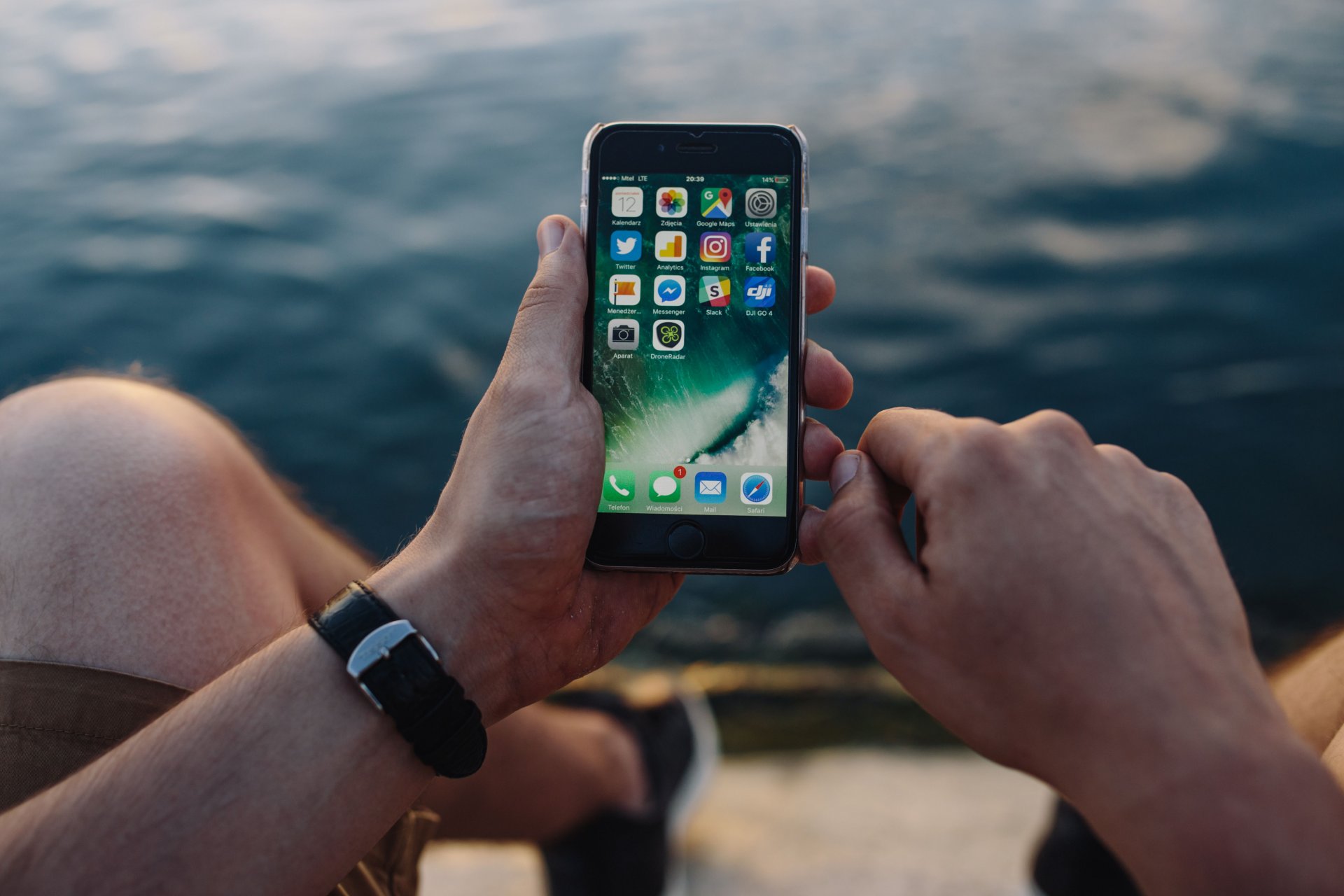 kaboompics_Mobile phone in mans hands near the sea (4).jpg