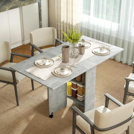 Mesa de Cocina Plegable con Ruedas 2 Estantes de Almacenaje y 2 Alas Abatibles Estilo Moderno 75x140x74 cm Gris Cemento