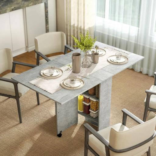 Mesa de Cocina Plegable con Ruedas 2 Estantes de Almacenaje y 2 Alas Abatibles Estilo Moderno 75x140x74 cm Gris Cemento